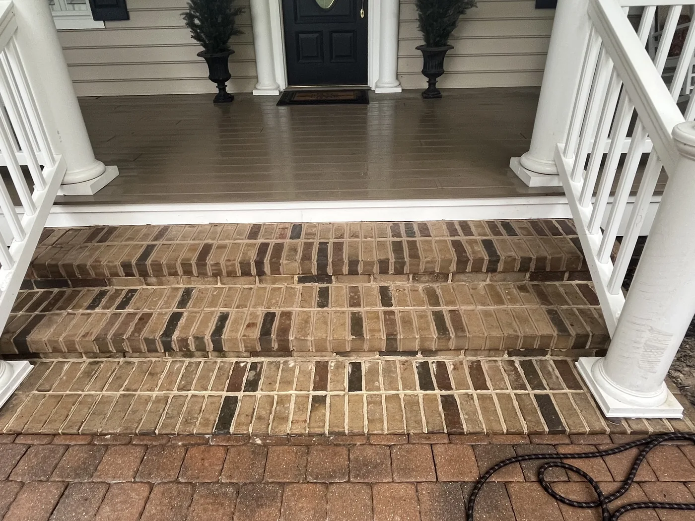 New brick porch steps leading up to a covered front porch, masonry contractor work