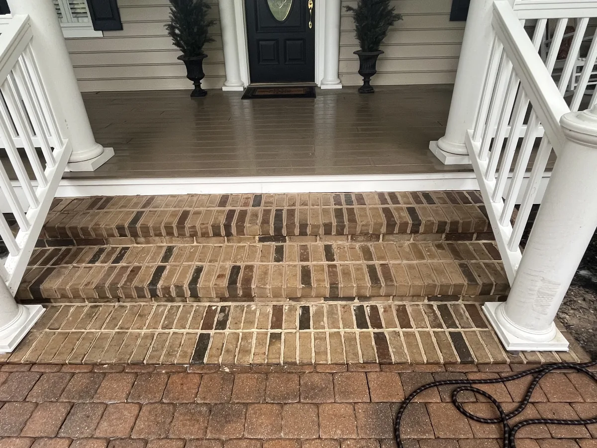 New brick porch steps leading up to a covered front porch, brick masonry
