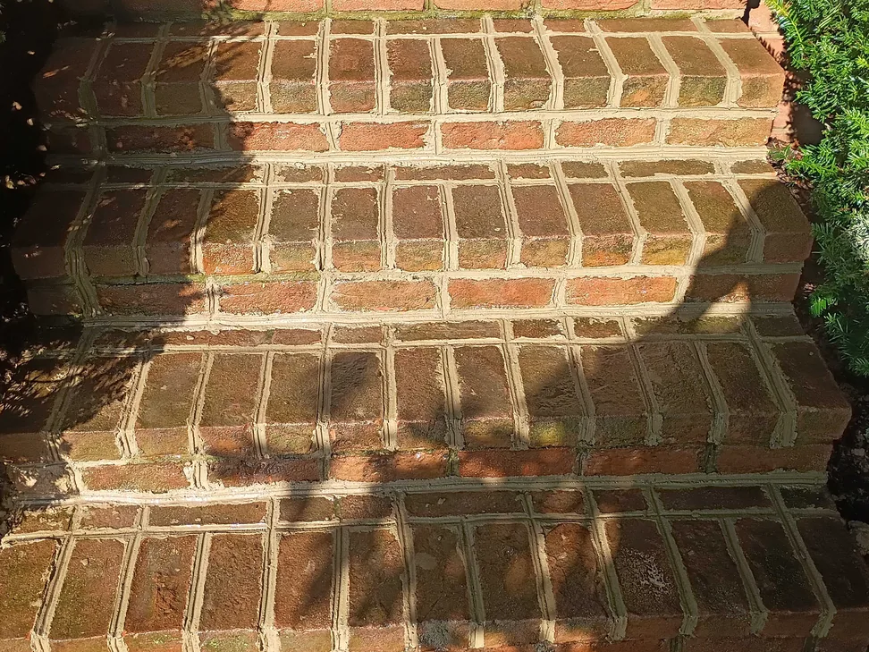 Old brick steps with fresh mortar joints, brick repair