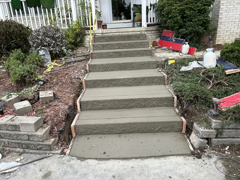 Freshly poured concrete front steps with the side forms still on, concrete work