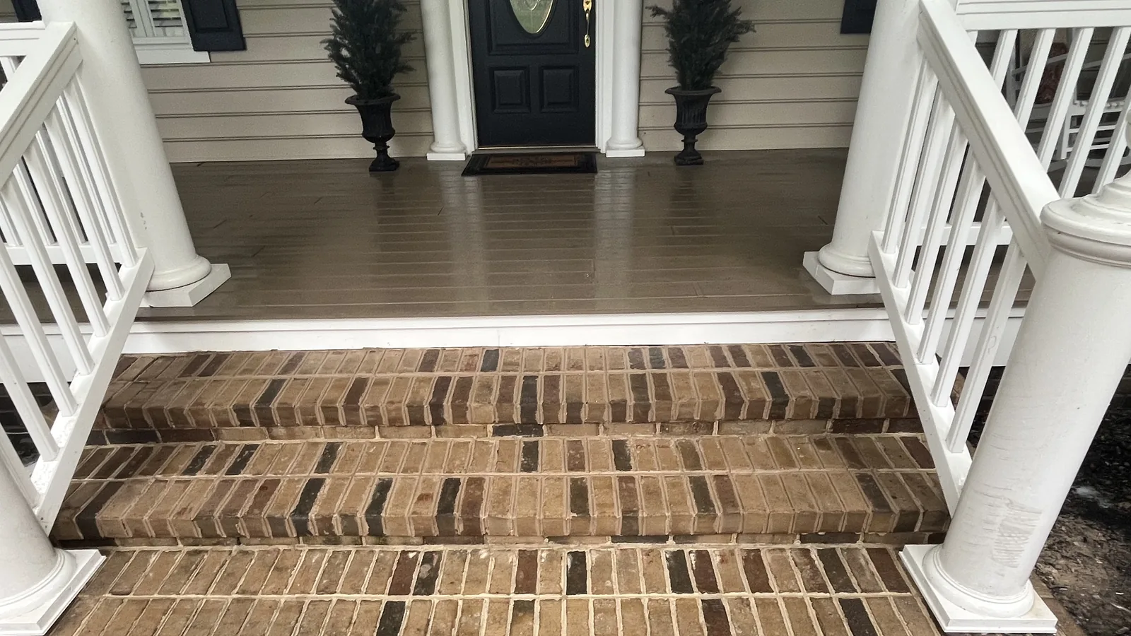 Masonry contractor work: new brick porch steps with soldier course treads below a covered front porch