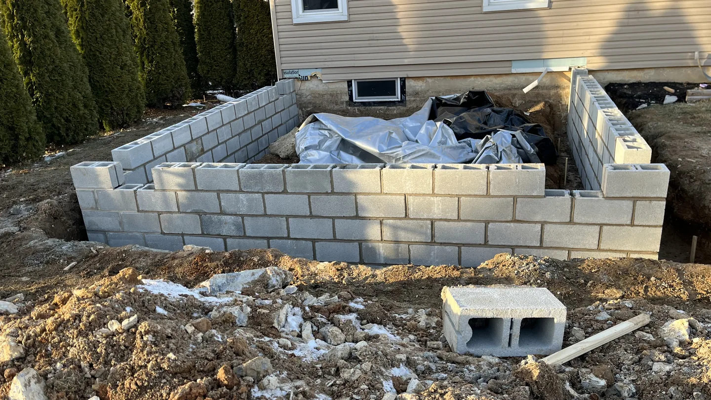 New concrete block foundation walls for a home addition, masonry contractor work