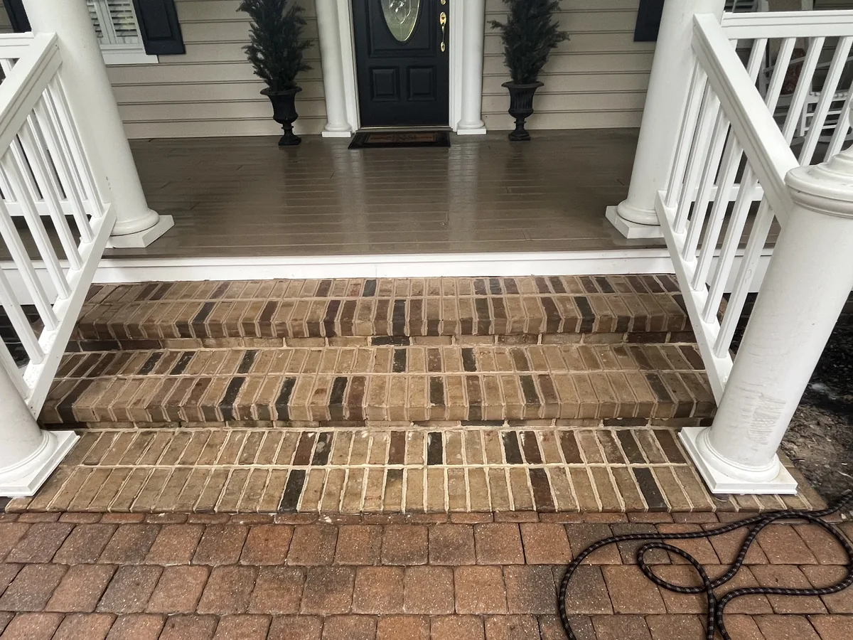 New brick porch steps leading up to a covered front porch, walkways and steps