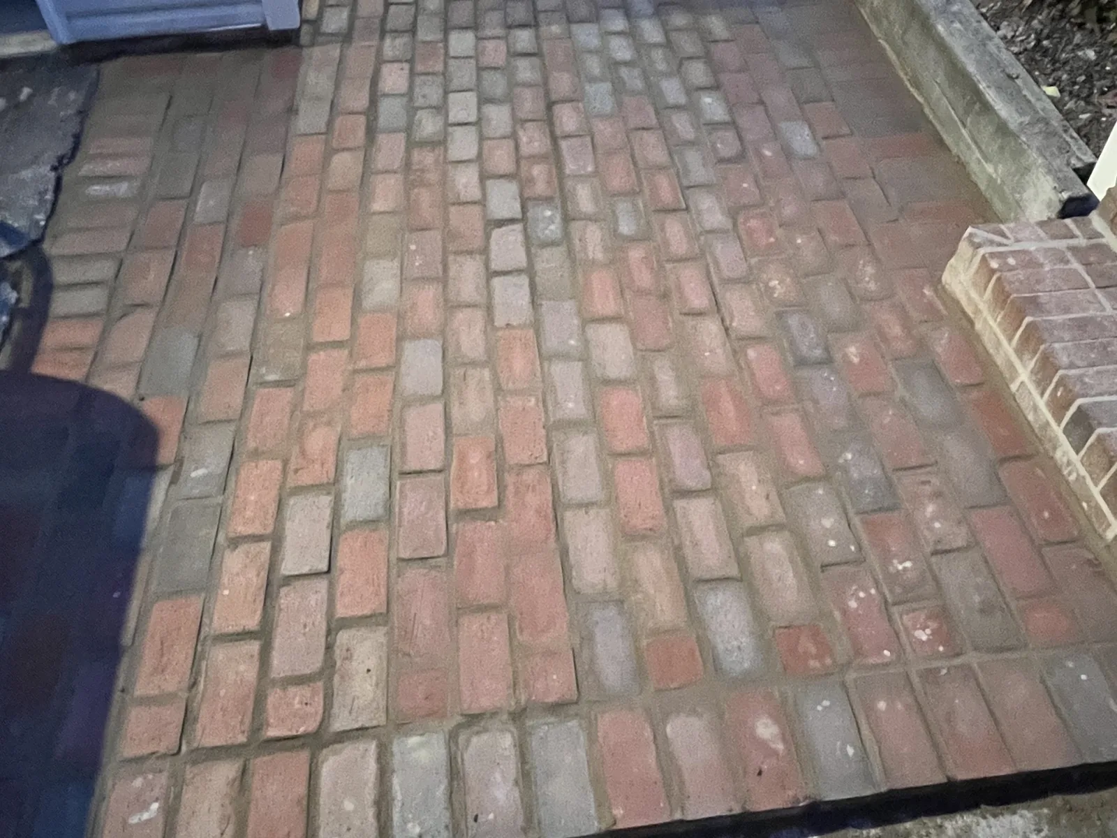 A new brick walkway laid in running bond beside a house, walkways and steps